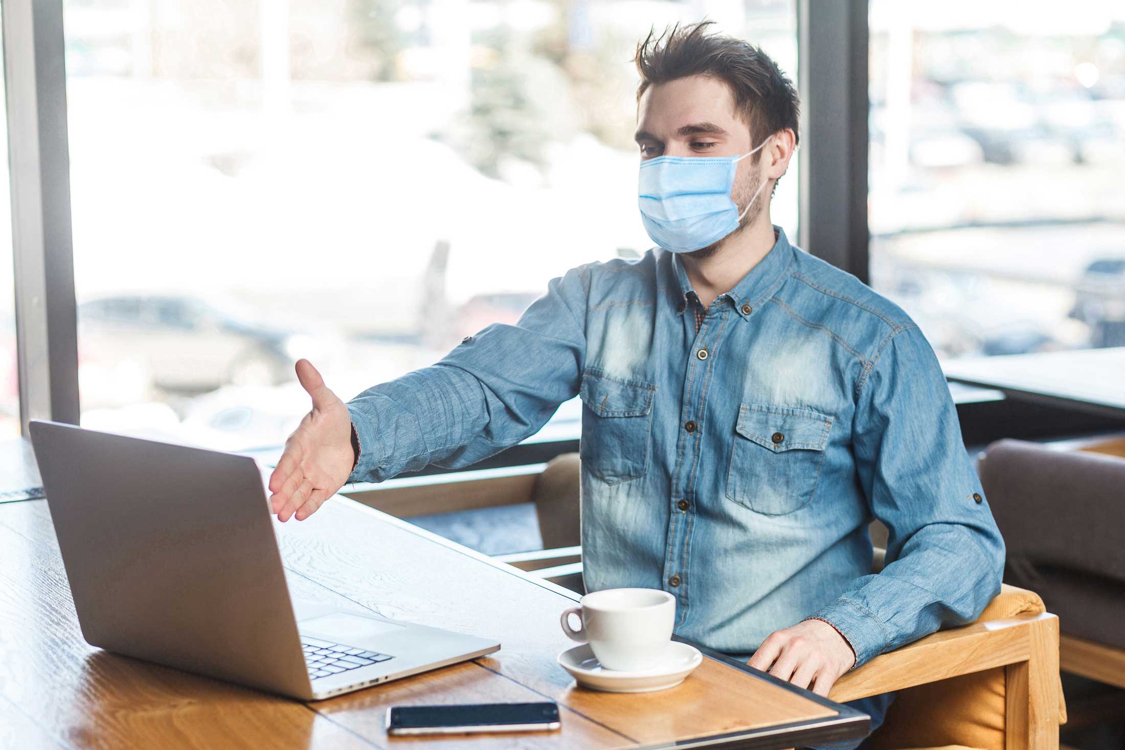 professional wearing a face mask on a video conference call